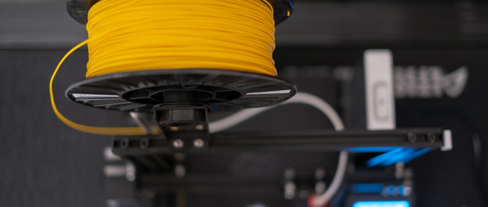 a spool of yellow wire sitting on top of a machine